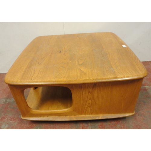 449 - Ercol blonde elm Pandora's Box coffee table of square form with two drawers to one end, flanked by o... 