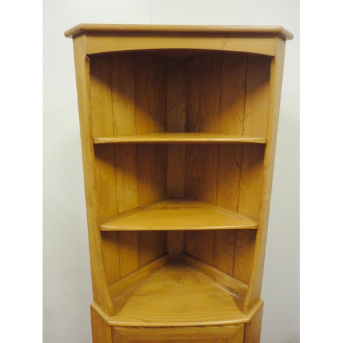 450 - Ercol blonde elm Windsor corner unit with open shelving above a cupboard door, enclosing a shelved i... 