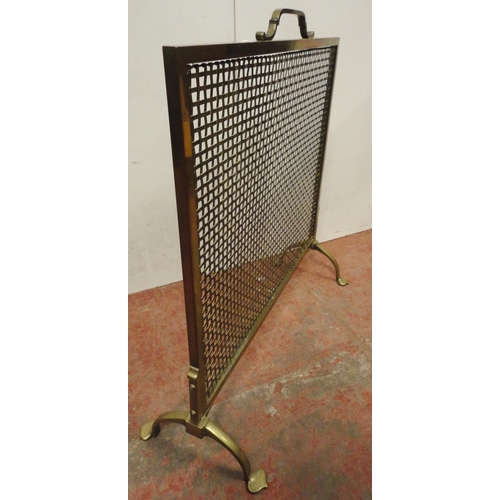 461 - Arts & Crafts brass fire screen with mesh protection screen, on splayed supports and stylised fe... 