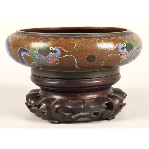 180 - Oriental Cloissone bowl with hardwood stand, characters to base, 21cm diameter