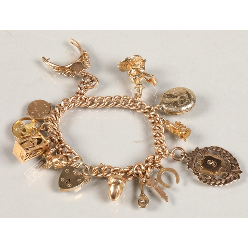 74 - 9ct gold charm bracelet, total weight 59.3g