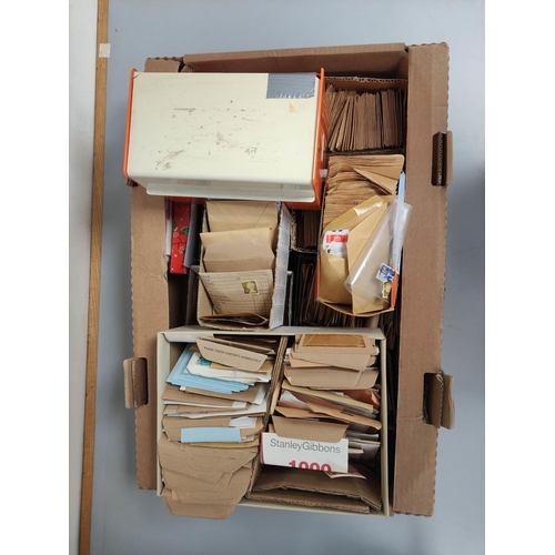 415 - Box containing a large quantity of mixed World postage stamps contained within envelopes.