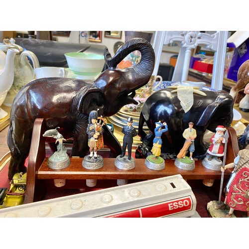 278 - Bottle stopper set to include piper, police officer, golfer, etc; elephant figures, model cars and t... 