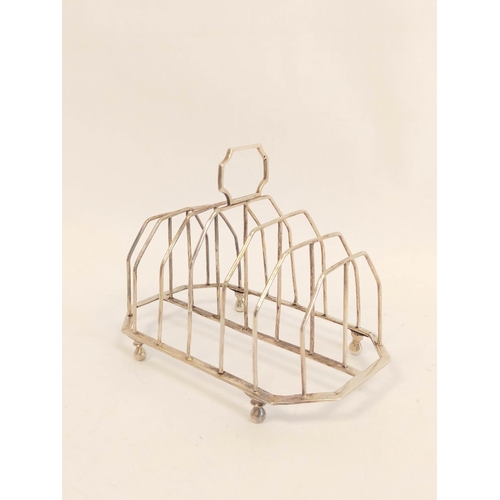 166 - Silver toast rack for six with plain wires and angled handle and base on bun feet by S Hennell, 1805... 