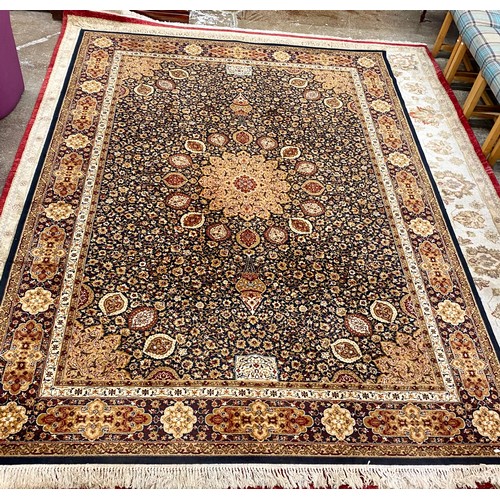 573 - Red and cream on black ground Persian style woolen carpet, 337 x 250 cm