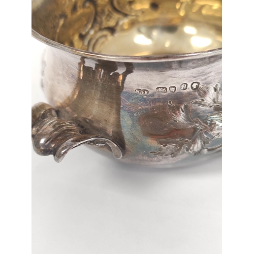 103 - Silver porringer embossed with scrolls, with similar handles by W.K Reid 1848, 191g, 6oz.