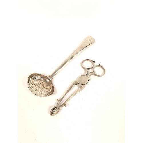 107 - Silver sifter spoon, crested, by Thomas Daniell 1801 and a pair of sugar nippers, C1760. 70g, 2oz.