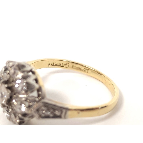 121 - Diamond nine stone cluster ring in gold '18ct platinum' 1930's. Size 'K½'. 3.4g