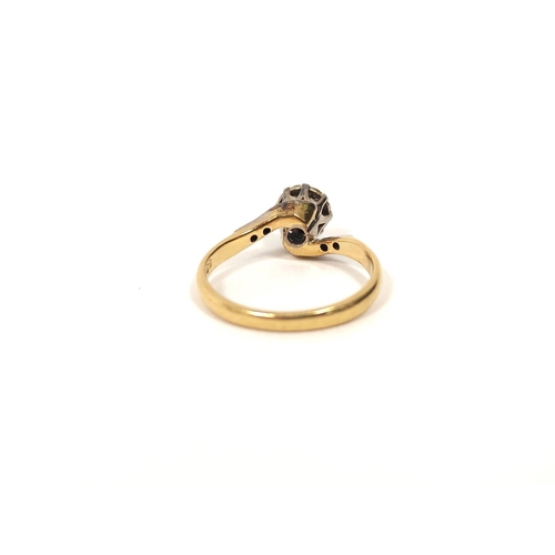 128 - Diamond solitaire cross-over ring in gold, '18ct' size 'L'