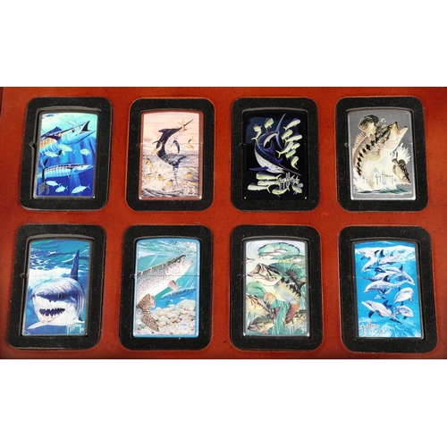 165 - Eight various limited edition Zippo lighters in Zippo display case including Guy Harvey (8)