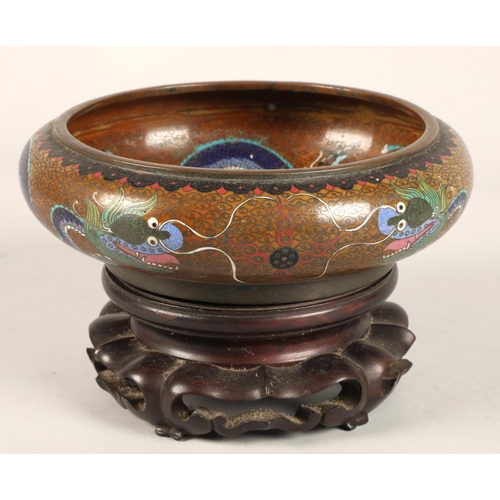 180 - Oriental Cloissone bowl with hardwood stand, characters to base, 21cm diameter