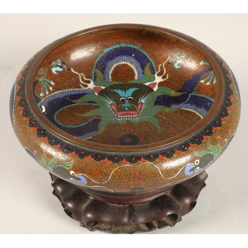 180 - Oriental Cloissone bowl with hardwood stand, characters to base, 21cm diameter