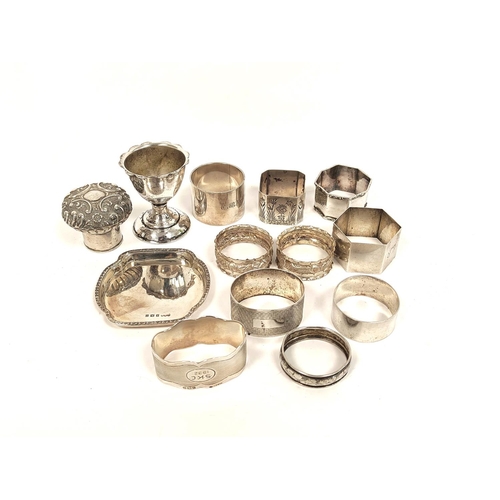 95 - Silver small dish, a bottle cap, an egg cup and nine napkin rings, various. 314g.