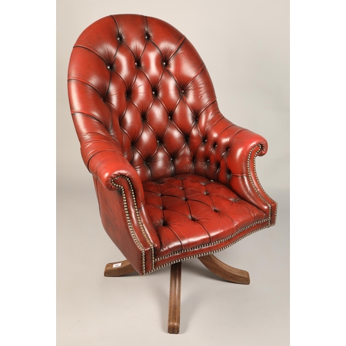 568 - Red leather Chesterfield-style swivel chair, approx. 110cm