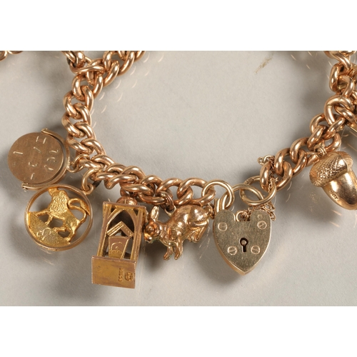 74 - 9ct gold charm bracelet, total weight 59.3g