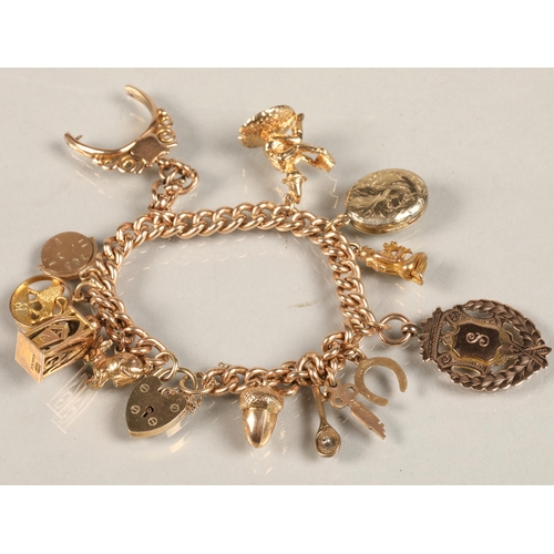 74 - 9ct gold charm bracelet, total weight 59.3g