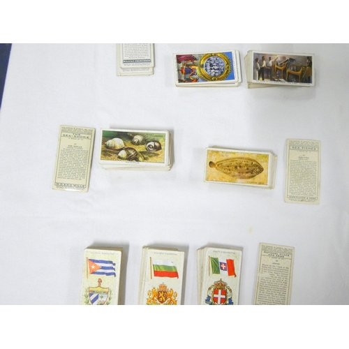 87 - Players cigarette cards including Treasure Trove, Churchman's, National Flags, Sea Fishes.