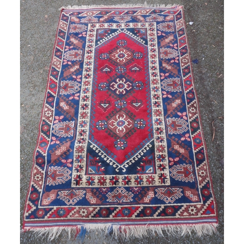 414 - Turkish Belouch hand-knotted rug with three geometric lozenges to the centre, flanked by a band of f... 