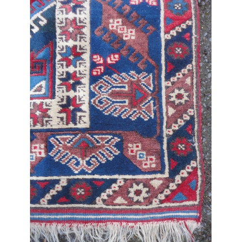 414 - Turkish Belouch hand-knotted rug with three geometric lozenges to the centre, flanked by a band of f... 