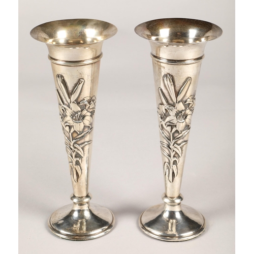 175 - Pair of silver weighted spill vases, with embossed floral decoration, assay marked London 1906,maker... 