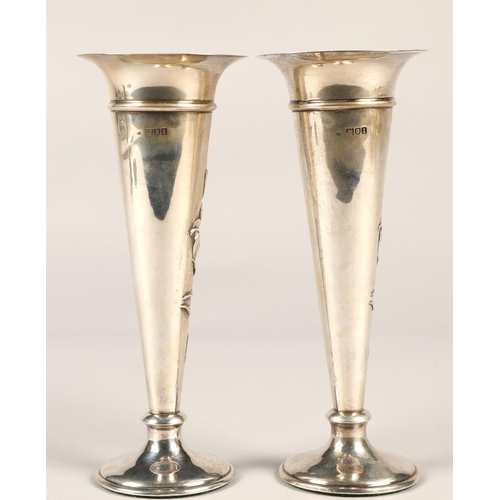 175 - Pair of silver weighted spill vases, with embossed floral decoration, assay marked London 1906,maker... 