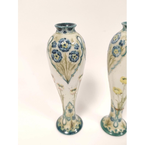 329 - Pair of William Moorcroft for MacIntyre Florian ware vases from the Art Nouveau era, the tapered bal... 