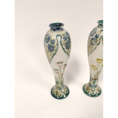 329 - Pair of William Moorcroft for MacIntyre Florian ware vases from the Art Nouveau era, the tapered bal... 