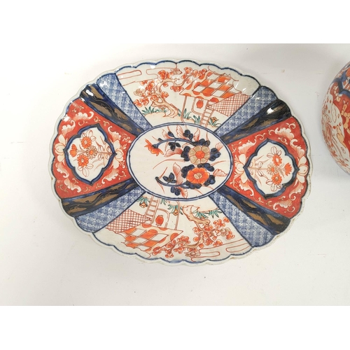 367 - Japanese Meiji period Imari pottery serving dish, with wavy rim and foliate and landscape borders, t... 