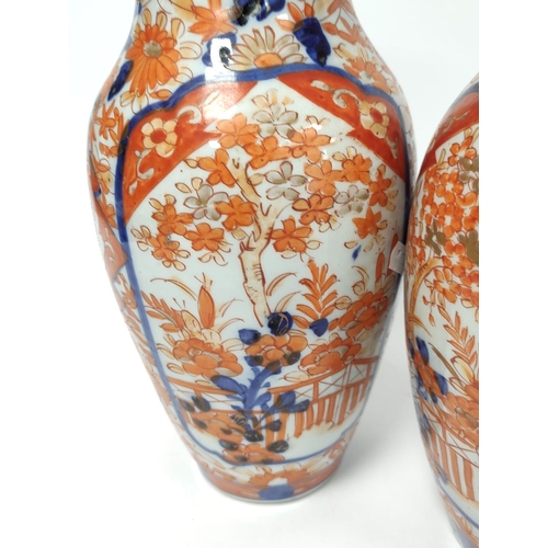 370 - Pair of Japanese Meiji period imari vases, With allover foliate borders, 31cm high. (2)