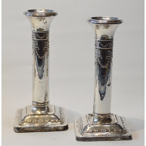 70 - Pair of silver boudoir dwarf candlesticks, embossed, Birmingham 1912, 15cm, loaded.