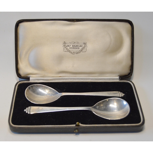 78 - Pair of silver dwarf candlesticks, loaded, and a pair of silver spoons, cased.