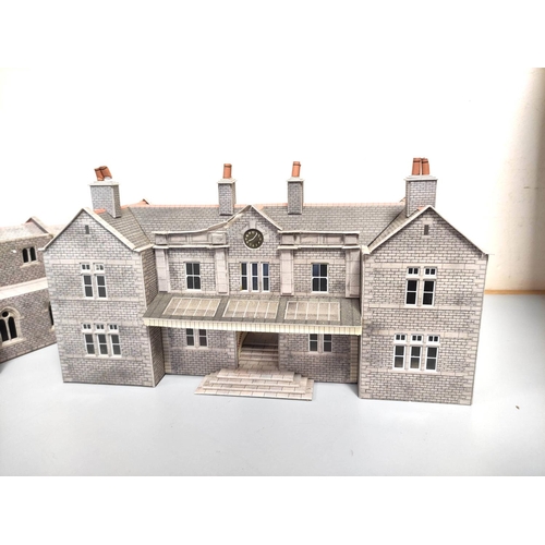 247 - Two boxes of model railway buildings and track components to include a church, station building, com... 