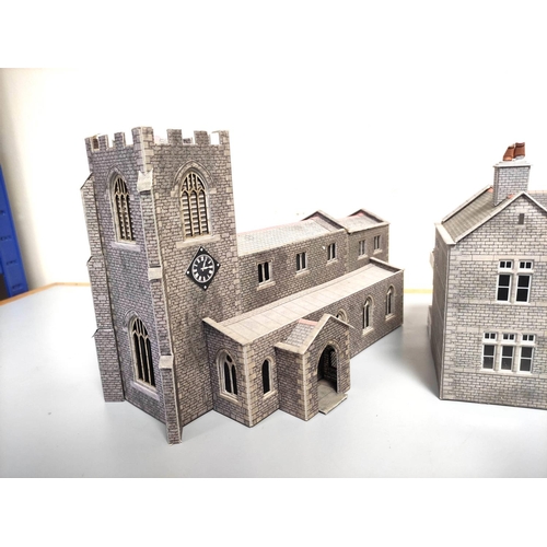 247 - Two boxes of model railway buildings and track components to include a church, station building, com... 