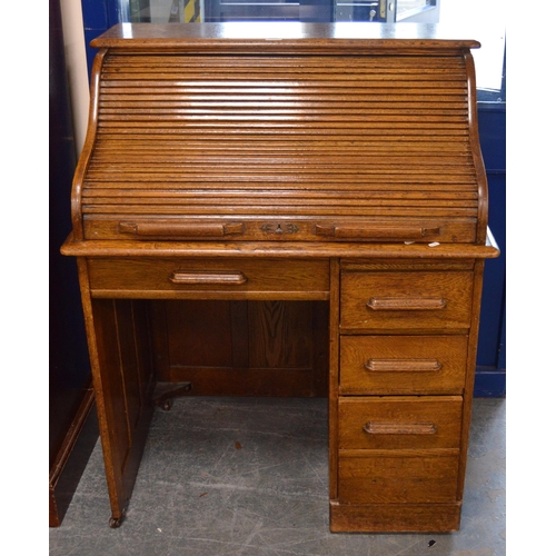 474 - Oak roll-top desk, c. 1930s, with tambour roller shutter enclosing drawers and pigeonholes, above th... 