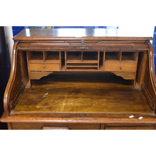 474 - Oak roll-top desk, c. 1930s, with tambour roller shutter enclosing drawers and pigeonholes, above th... 