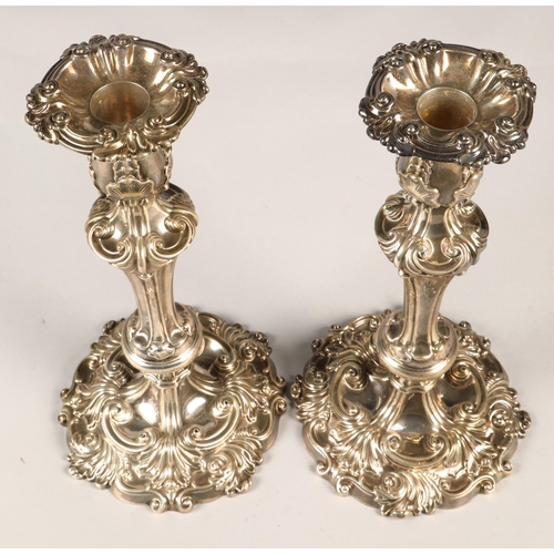 180 - Pair of ornate Georgian silver weighted candlesticks , assay marked Sheffield 1824, maker Waterhouse... 