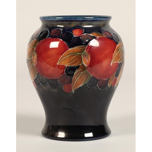 9 - Moorcroft pottery vase of baluster form, pomegranate pattern, blue signature to base, 15cm high.