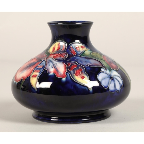 13 - Moorcroft pottery vase, of squat form, blue ground in the iris pattern, impressed mark with blue sig... 