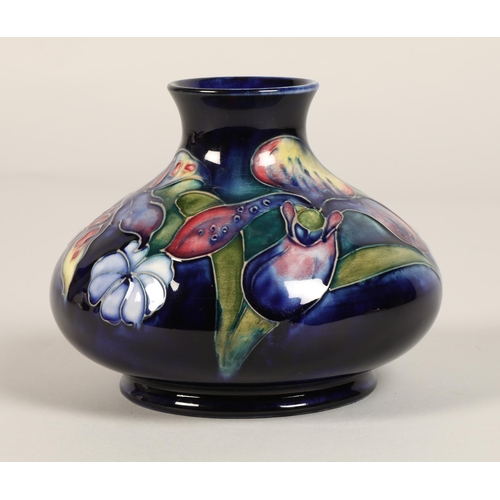 13 - Moorcroft pottery vase, of squat form, blue ground in the iris pattern, impressed mark with blue sig... 