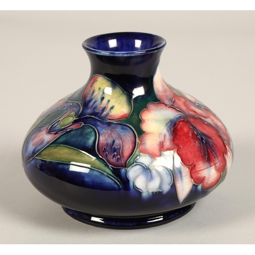 13 - Moorcroft pottery vase, of squat form, blue ground in the iris pattern, impressed mark with blue sig... 