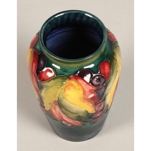 10 - Moorcroft pottery vase of baluster form decorated in the leaf & berry pattern, 13cm high.