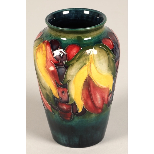 10 - Moorcroft pottery vase of baluster form decorated in the leaf & berry pattern, 13cm high.