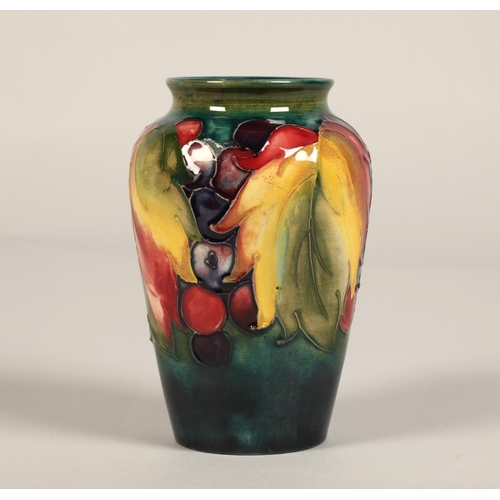 10 - Moorcroft pottery vase of baluster form decorated in the leaf & berry pattern, 13cm high.