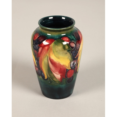 10 - Moorcroft pottery vase of baluster form decorated in the leaf & berry pattern, 13cm high.