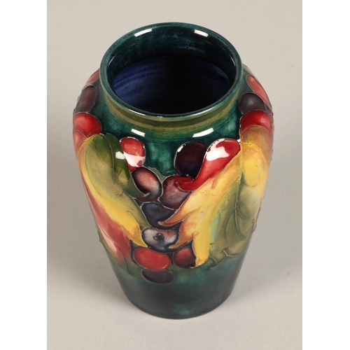 10 - Moorcroft pottery vase of baluster form decorated in the leaf & berry pattern, 13cm high.