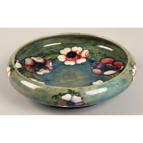 14 - Moorcroft shallow pottery bowl in the anemone pattern on blue and green ground, impressed marks and ... 