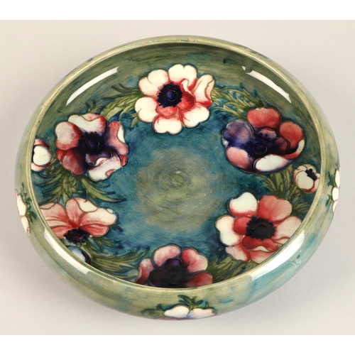 14 - Moorcroft shallow pottery bowl in the anemone pattern on blue and green ground, impressed marks and ... 