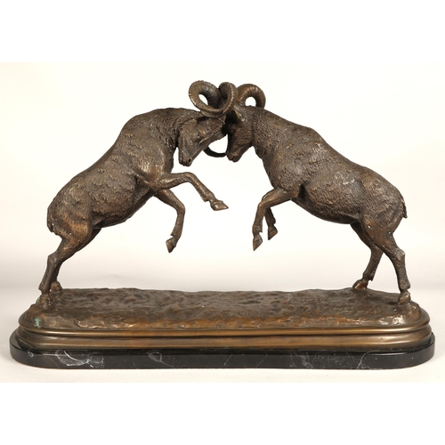 247 - Twentieth century figure of two rams fighting on marble base, signed T R, 75cm long, 47cm high