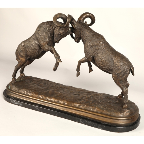 247 - Twentieth century figure of two rams fighting on marble base, signed T R, 75cm long, 47cm high