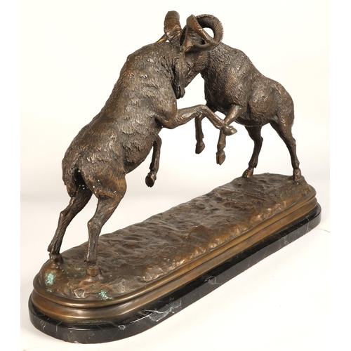 247 - Twentieth century figure of two rams fighting on marble base, signed T R, 75cm long, 47cm high